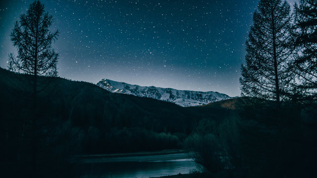 winter landscape with mountains. landscape with stars. man on the background of stars