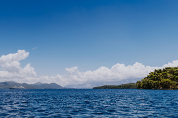 Greek Island viewed from the sea. Beautiful sea landscapes on Island in Greece. In distance is famous Scorpios island, from the left side is Lefkada island and from right is a part of gorgeous