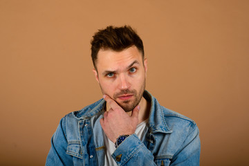 Obraz premium Handsome man standing and smiling isolated on light brown studio background. Male half-length portrait. The human emotions, facial expression concept. Front view.