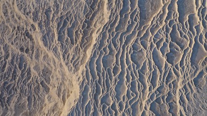 Aerial top down view of Pamukkale thermal pools, cascade of mineral hot springs, Beautiful patterns of limestone formations. Famous place travel destination UNESCO landmark in Turkey.
