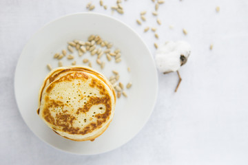 Homemade pancakes on kefir on a white plate. Cooking at home, home-cooked food. Space for text.