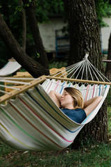 Young woman relaxing in the hammock in nature