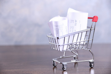 Checks from purchases from shops and shopping cart. Close up