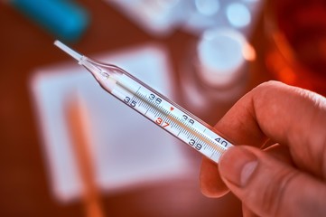 Mercury thermometer in hand