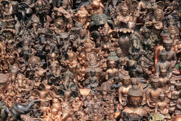 Large group of various bronze figurines of Hindu deities and Buddhas in a souvenir shop in Kathmandu city, Nepal. Street retail theme.