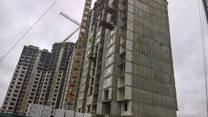 construction crane near the building against the sky