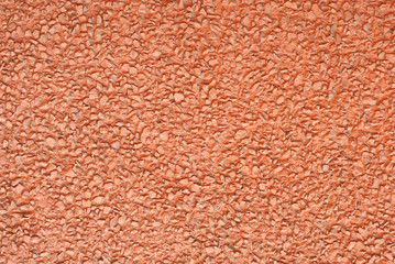 Concrete wall texture close up. Red art plaster.