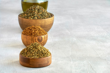Mixed spice zaatar or zatar in wooden bowls, Various type of zaatar blend. Close up with copy space