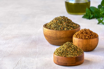 Mixed spice zaatar or zatar in wooden bowls, Various type of zaatar blend. Close up with copy space