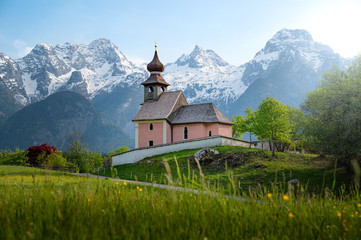 Fototapeta na wymiar Idyllic pilgrimage church with snow-capped mountains in the background