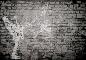Grunge decayed faded brick wall background with musician playing the saxophone with copy space for own text