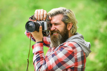 Enjoying hot day. bearded man hipster take photo. photo shooting outdoor. brutal man traveler with retro camera. photography in modern life. travel tips. professional photographer use vintage camera