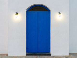 Image of old blue door with lights. Entrance to the Greek old church