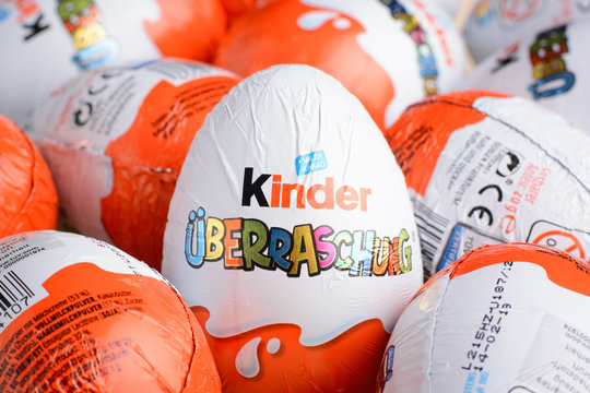Ukraine, Kiev - December 25, 2018: Kinder Surprise Egg stands between many other eggs. Chocolate egg is a sweet present by Italian confectionery manufacturer Ferrero SpA.