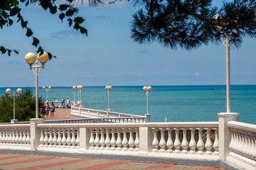 The embankment of the resort of Gelendzhik in clear Sunny weather. White balustrade and street lights. In the background Black Sea