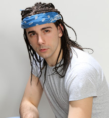 Stylish male model with afro braids posing in studio on isolated background. Style, trends, fashion...