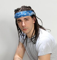 Stylish male model with afro braids posing in studio on isolated background. Style, trends, fashion...