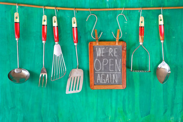 Restaurant announcing reopening after the corona lockdown on blackboard, gastronomy business...