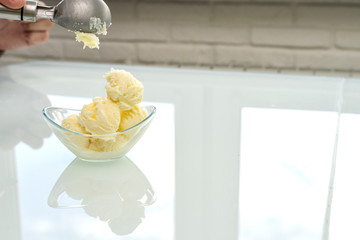 a scoop of ice cream is placed in a glass bowl, place for text