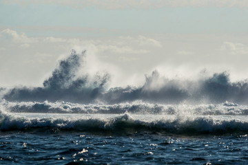 A huge wave for surfing . The photo was taken from the water in the Indian Ocean island of Mauritius