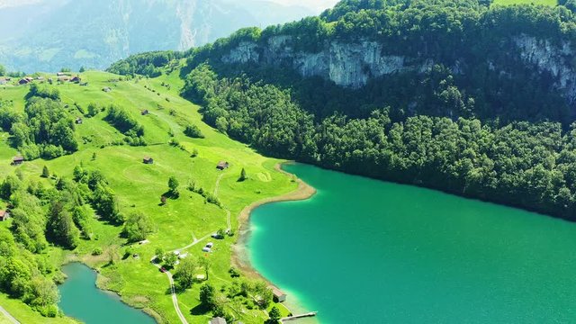 The Seelisberg is a lake below the village  in the canton Uri, Switzerland. The lake is about 18 ha, 700 to 800 m long, 350 m wide and 37 m deep. Cinematic drone video.