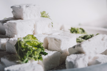 White Homemade Marshmallows with the Mint. Pyramid of Marshmallow. Pile of square Marshmallows.