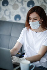 a woman in a mask and gloves works on a laptop, a doctor during the pandemic