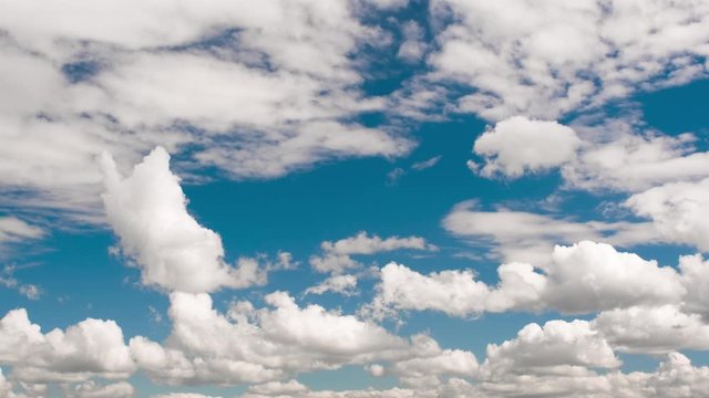 White Clouds motion on blue sky background. Time Lapse 4k, clean, no birds. Summer spring season concept.