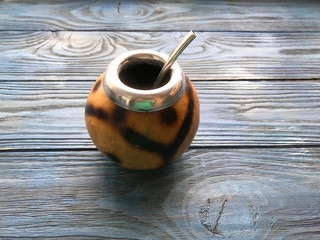calabash and mate bombilla on wooden background

