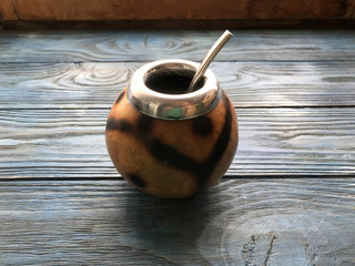 calabash and mate bombilla on wooden background

