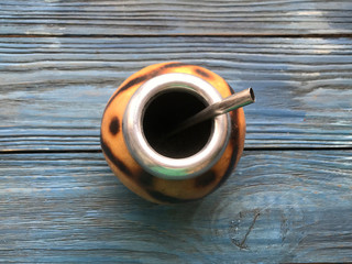 calabash and mate bombilla on wooden background

