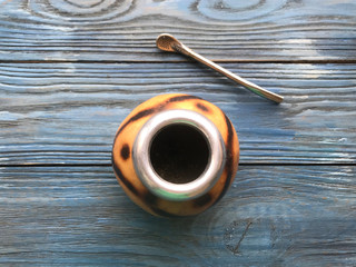 calabash and mate bombilla on wooden background

