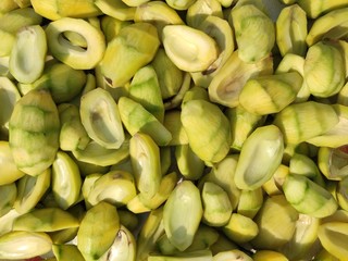 part of Bengali seasonal fruit,the unripened mango, it's seed, it's slices and pieces are arranged. Used as spice during cooking vegetables as aamchoor powder.