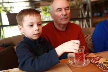 Grandfather and grandson in restaurant