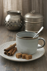 Obraz na płótnie Canvas Coffee with cinnamon and silver utensils