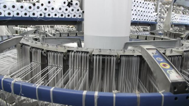 White conical column whirling and knitting large plastic tissues at agro plant