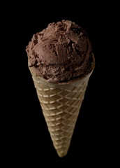 Chocolate ice cream in cone, isolated on black background with clipping path