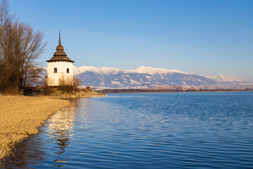 Fototapeta na wymiar Church of Virgin Mary in Havranok and lake Liptovska Mara, district Liptovsky Mikulas, Slovakia