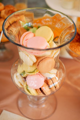 Sweet macaroon cookies served on a glass plate. Candy bar concept.
