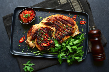 Chicken tabaka - traditional dish of georgian cuisine. Top view with copy space.