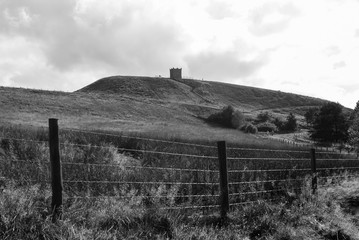 Rivington Pike in black and white with fence in foreground