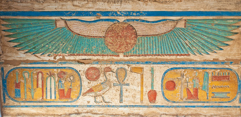 Hieroglyphic carvings on an ancient egyptian temple wall