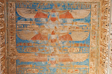 Hieroglyphic carvings on an ancient egyptian temple wall