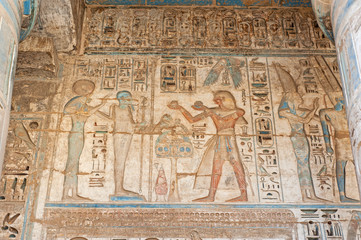 Hieroglyphic carvings on an ancient egyptian temple wall