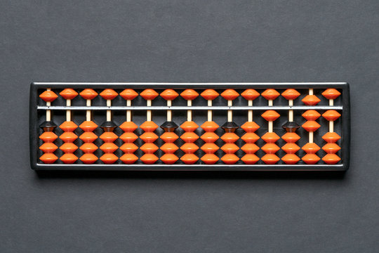 Abacus for mental math on black background. Mathematics learning, education school arithmetic concept