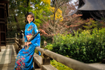portrait of asian woman wearing japanese blue kimono and umbrella on holding hand
