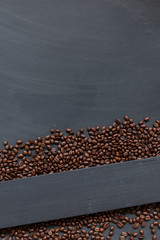 coffee bean on black wooden floor background. top view. space for text