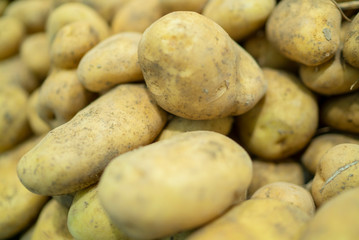 fresh potatoes standing at the market counter
