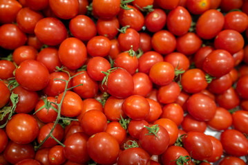 delicious and red tomatoes standing on market counter
