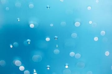 Bubbles are blurred from in the alcohol gel bottle and the blue background.